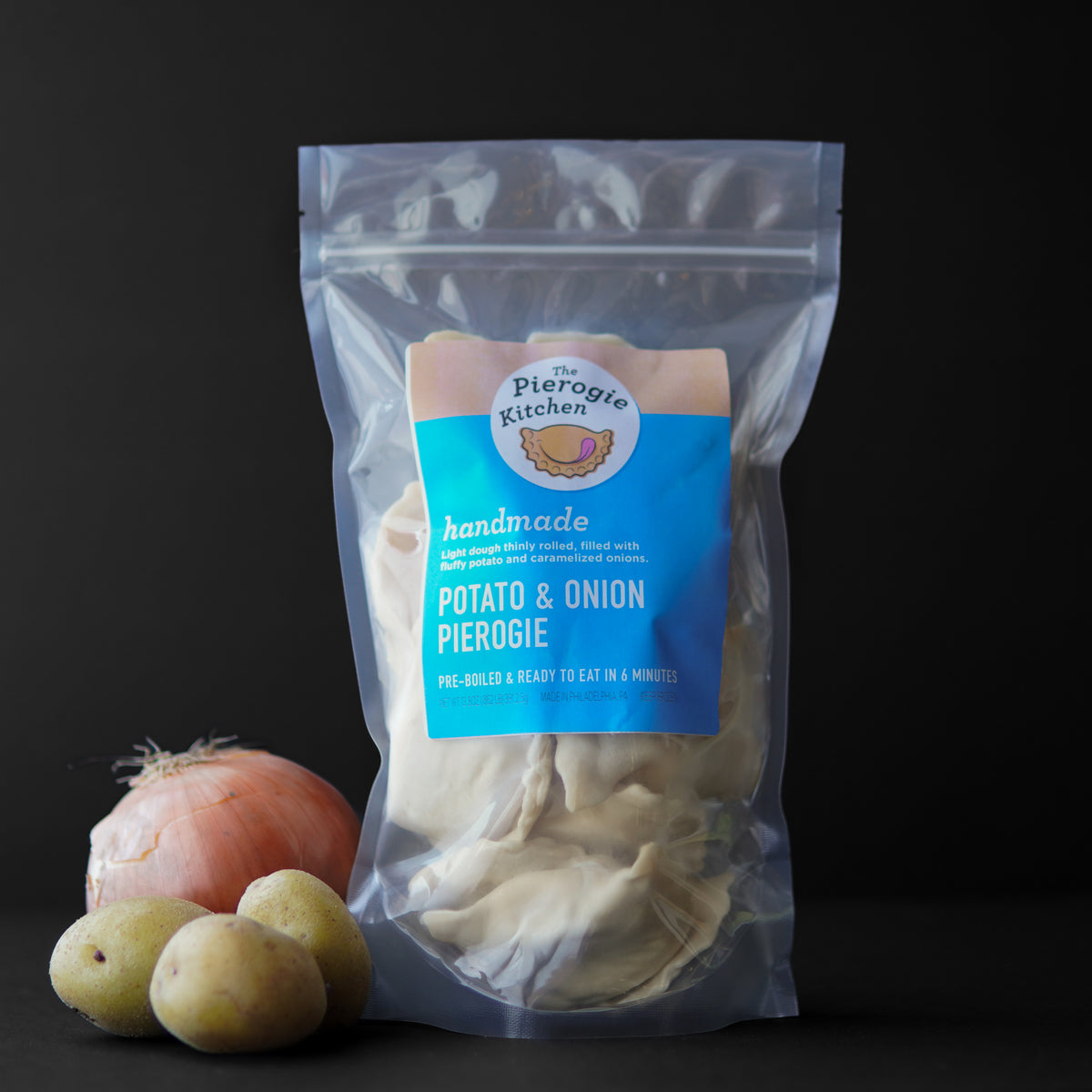 Frozen potato and onion pierogie pouch in clear plastic bag with blue label